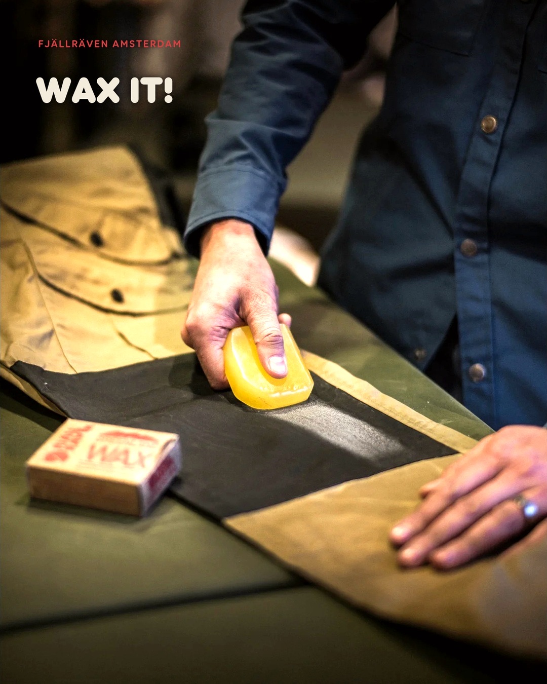 Fjällräven Amsterdam Instagram post: hands waxing a G-1000 jacket with a bar of Greenland Wax, headline Wax It!